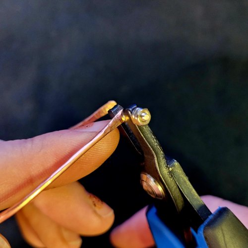 Jennifer Brooks's Rainbow Autumn Tree Earrings - , Contemporary Wire Jewelry, Dapping, Dapping Jewelry, How To Punch Holes, Hole Punching, Punch A Hole, Lashing, Wire Lashing, , Use a hole punch to make a hole in the hammered paddle tip end